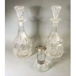 A pair of late 19th / early 20th century facet-cut, mallet-shaped decanters with star-cut bases