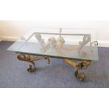 A very stylish glass-topped designer coffee table; very heavy and elaborate gilded wrought-iron