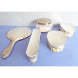 Silver-backed dressing table requisites to include a hand-held mirror, clothes brushes and a lady'