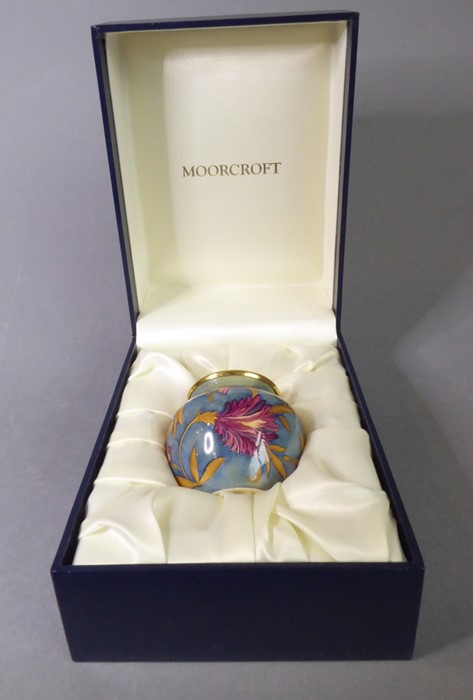 A miniature Moorcroft vase; finely hand-painted enamel fired onto copper, decorated with florid