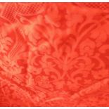 A bright-red lined damask curtain (approx. 320cm hem x 214cm drop) with triple pleat head,