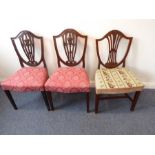 A pair of late 18th century Hepplewhite-period mahogany salon chairs; shield-shaped backs and