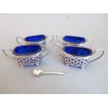 A set of four late Victorian hallmarked silver two-handled reticulated salts; each having cobalt-
