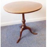 An early 19th century circular tilt-top occasional table; turned stem and tripod base (66cm wide)