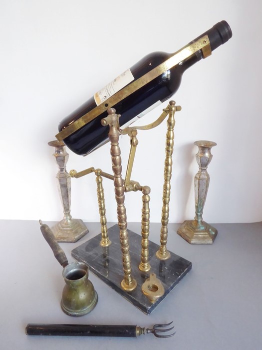 An assortment of four: a brass wine-pourer on a marble base, a pair of brass and silver-plated