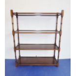 A wall-mounted set of mahogany shelves with turned annulated uprights (61cm wide x 20cm deep x
