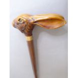 A turned walking cane (possibly stained maple); the composition handle modelled as a hare's mask (