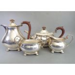 A heavy hallmarked silver four-piece tea service comprising teapot, hot-water pot, two-handled sugar