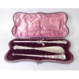 A lady's cased travelling three-piece dressing table set: glove stretchers, shoe horn and boot pull,