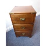 A small mahogany and brass-mounted campaign-style three-drawer chest; recessed brass handles, raised