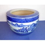 A large Chinese ceramic blue and white planter decorated with continuous landscape above lotus-style