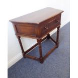 A reproduction oak credence-style table; the single full-width front arcaded drawer flanked by