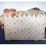 An upholstered bedhead in purple, yellow and green decorated with roses (90cm x 138cm), together