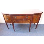 A George III period mahogany and ebony-strung breakfront sideboard; central flush drawer above a