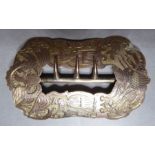 A 19th century American shoe or hat buckle engraved with eagles, flags, cannon and rifles etc.,