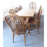 An oak refectory-style table together with a harlequin set of eight (6+2) wheelback chairs with