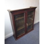 A late 19th / early 20th century stained-pine display cabinet having two glazed doors enclosing