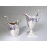 A George III period hallmarked silver helmet-shaped cream jug with high arch handle and a band of