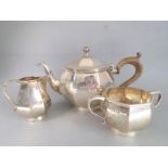 A heavy hallmarked silver three-piece tea service comprising teapot, two-handled sugar and milk jug;