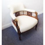 A late 19th/early 20th century upholstered mahogany and marquetry open tub-style chair, raised on