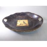 A 19th century boat-shaped papier-mâché dish; the pierced heart-shaped handles flanking central