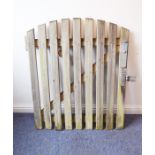 An oval topped wooden garden gate; nine vertical wooden slats, locking bar and hinges (110cm highest