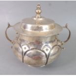 A hallmarked silver two-handled porringer with cover; late 17th century Charles II reproduction,