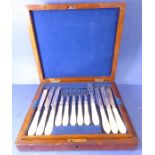 A walnut-cased 12-place set of 19th century hallmarked silver-bladed tea knives and forks (one