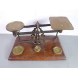 A 19th century set of brass postage weighing scales with five concentric circular brass weights;