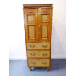 A slim late 19th century Aesthetic-style satin walnut and Hungarian ash side cabinet; the bow-