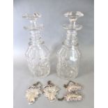 A pair of late Georgian ring-necked cut-glass decanters with original stoppers; together with two