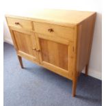 A mid-20th century War Department oak sideboard; two half-width drawers (one fitted for cutlery)