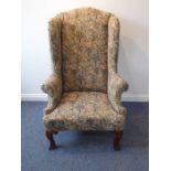 A large early 20th century wing-backed armchair in early 18th century style; medieval-style tapestry