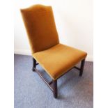 An early George III period 18th century upholstered low chair on chamfered square legs united by