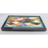 A modern Italian pietra dura paperweight; geometric design of specimen stones including malachite,