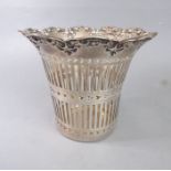An early 20th century hallmarked silver basket having repousse-style C-scroll decoration to the