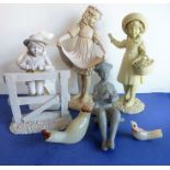 A selection of various decorative composition figures to include a child leaning over a three-bar