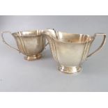 A heavy, hallmarked silver two-handled sugar with matching cream jug, assayed Chester 1937 (total