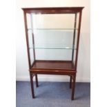 An early 20th century mahogany and glazed cabinet on stand in 18th century style; the glazed door