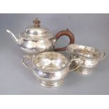An early 20th century hallmarked silver three-piece tea service: teapot, milk jug and two-handled
