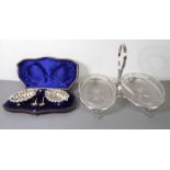 An early 20th century double sweetmeat dish, together with a circa 1900 cased pair of silver-plate