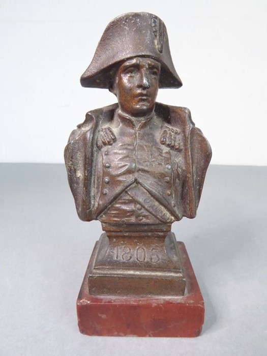 A small 19th century bronzed shoulder-length bust of Napoleon, upon square red marble base (9cm