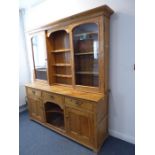 A good large late 19th century pine dresser; the shaped cornice above a centrally shelved
