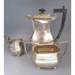 A hallmarked silver three-piece coffee service comprising coffee pot, two-handled sugar and milk/