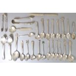 A good and interesting selection of 24 silver spoons (mostly teaspoons), two sugar tongs and a fruit