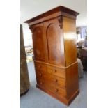 A large mid-19th century mahogany linen press; the outset cornice above two panelled doors enclosing