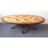 A stylish 1960s/70s French oak-framed and tiled oval occasional table; the tiled top depicting a