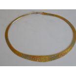 A three-colour collar necklace; the articulated textured bars in yellow, white and red sections,