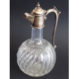 A 19th century cut-glass and silver-mounted globe and shaft-shaped claret jug; ornately engraved