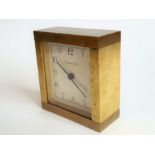 A heavy (probably gilt-bronze) alarm clock; the square white dial signed 'Tiffany & Co.' (9cm high)